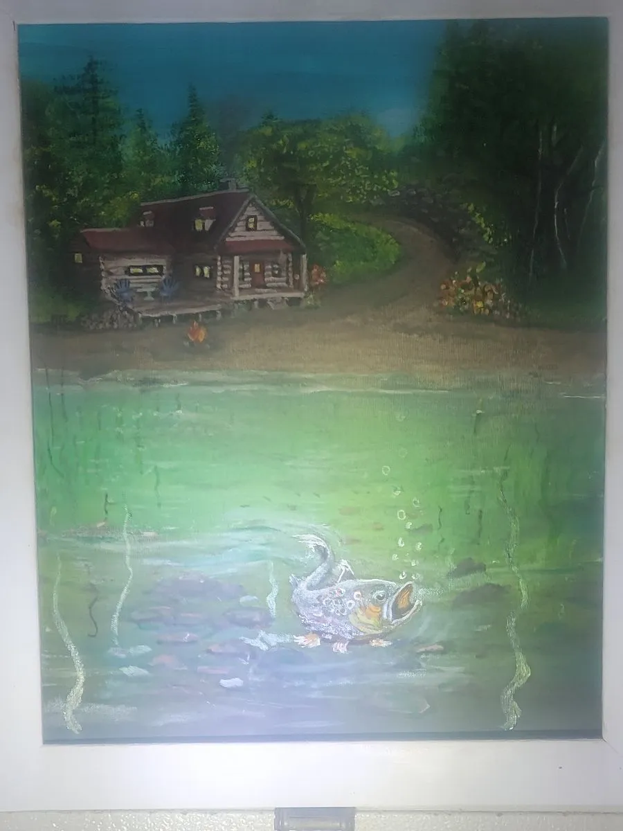 Underwater view of a trout below a green lake, with a log cabin and wooded shore above the waterline.